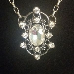 Unusual silver tone necklace with clear crystals